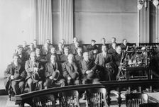 Candidates for naturalization seated in room, hats in laps, 1916. Creator: Bain News Service