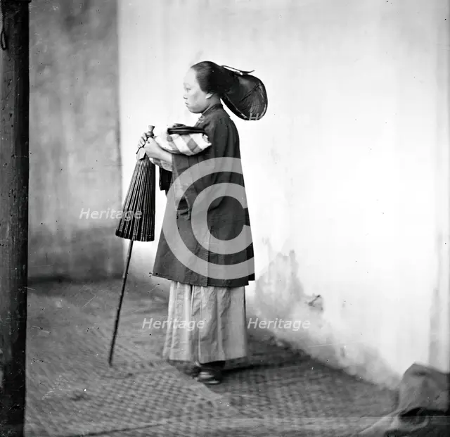 Canton, Kwangtung province, China: a lady holding a parasol, 1869. Creator: John Thomson.