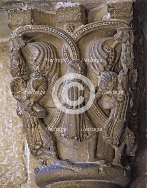 Capital decorated with the Good Shepherd with two figures on each side carrying a lamb and wolves…