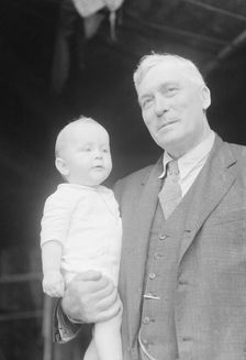 Captain Everett Edwards and baby, portrait photograph, 1933. Creator: Arnold Genthe