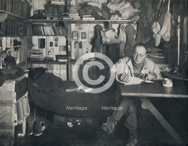 'Captain Scott Writing His Diary in the Hut at Cape Evans', c1911, (1914). Creator: Herbert Ponting.