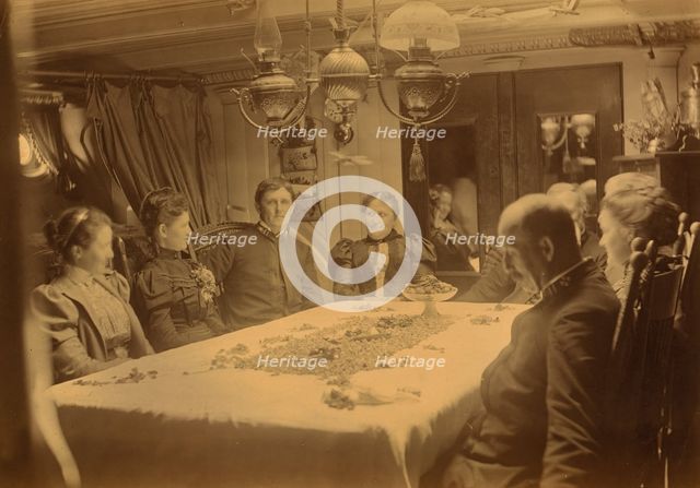 Captains, their wives, and two female tourists sitting around a table aboard ship...,Alaska, (1897?) Creator: Alfred Lee Broadbent.