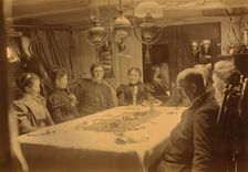 Captains, their wives, and two female tourists sitting around a table aboard ship...,Alaska, (1897?) Creator: Alfred Lee Broadbent