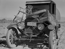 Car of drought refugee on edge of carrot field in the Coachella Valley, California, 1937. Creator: Dorothea Lange