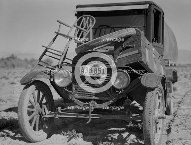 Car of drought refugee on edge of carrot field in the Coachella Valley, California, 1937. Creator: Dorothea Lange.