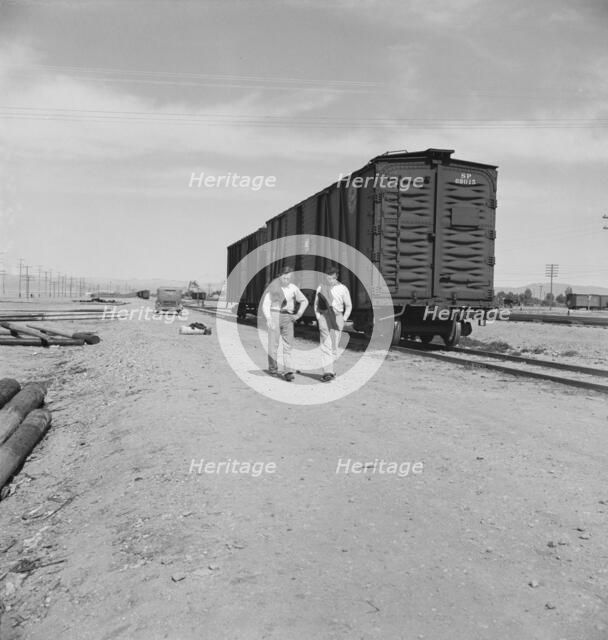 Car on siding across tracks from pea packing plant, Calipatria, Imperial Valley, 1939. Creator: Dorothea Lange.