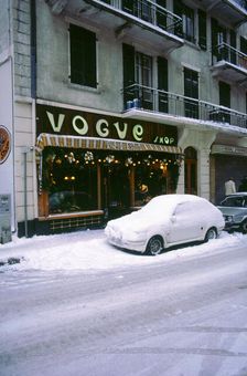 Car covered in snow in French street