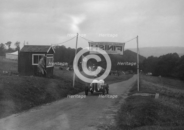 Car crossing the finishing line at the MAC Shelsley Walsh Speed Hill Climb, Worcestershire, 1935. Artist: Bill Brunell.