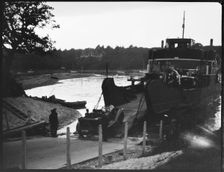 Car driving off the slipway on to the Isle of Wight Ferry at Fishbourne, Isle Of Wight, 1925-35. Creator: George R Long