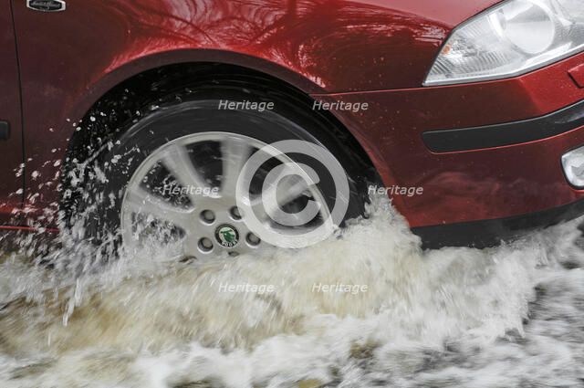 Car driving through flood. Artist: Unknown.
