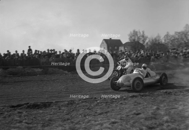 Car racing a motorbike on a dirt track, Arlöv, Scania, Sweden, 1947. Creator: Otto Ohm.