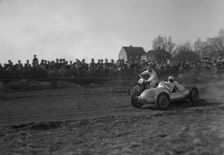 Car racing a motorbike on a dirt track, Arlöv, Scania, Sweden, 1947. Creator: Otto Ohm