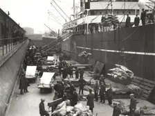 Cargo being loaded or unloaded from a ship, Royal Victoria Dock, Canning Town, London, c1930