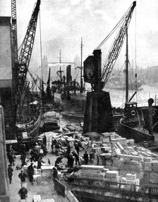 Cargo being unloaded at the docks, Upper Pool, London, 1936.Artist: Fox
