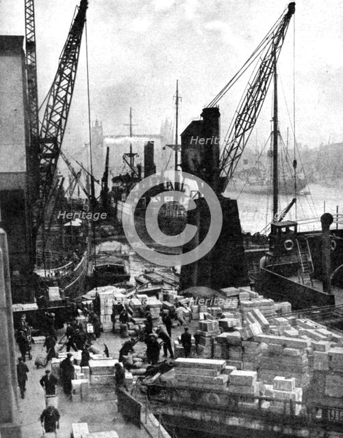 Cargo being unloaded at the docks, Upper Pool, London, 1936.Artist: Fox