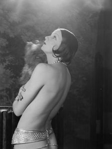 Carise, Erna, Mme., with dog, portrait photograph, 1928 Creator: Arnold Genthe
