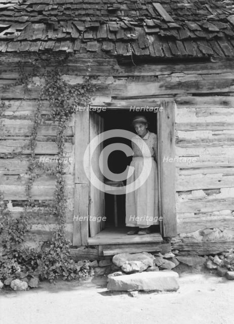 Caroline Atwater standing in the kitchen doorway of...log house, North Carolina, 1939. Creator: Dorothea Lange.
