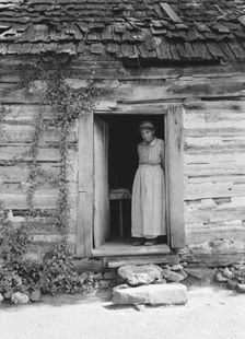 Caroline Atwater standing in the kitchen doorway of...log house, North Carolina, 1939. Creator: Dorothea Lange