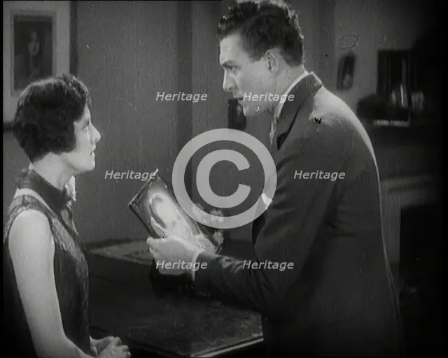 Carl Brisson and Lilian Hall-Davis Acting in a Scene. Carl Brisson is Holding a Framed..., 1920s. Creator: British Pathe Ltd.