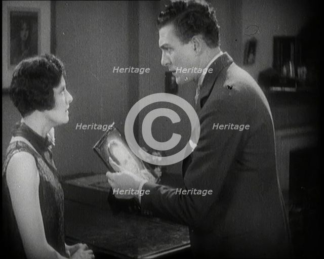 Carl Brisson and Lilian Hall-Davis Acting in a Scene. Carl Brisson is Holding a Framed..., 1920s. Creator: British Pathe Ltd.