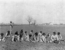 Carlisle Indian School, Carlisle, Pa. Boys digging for potatoes(?) in field, 1901. Creator: Frances Benjamin Johnston