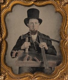 Carpenter in Top Hat with Hatchet, Compass, Square, and Hand Saw, 1850s-60s. Creator: Unknown