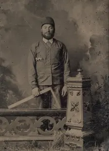 Carpenter, Standing Behind a Decorative Balustrade, Holding a Square, 1870s. Creator: Unknown