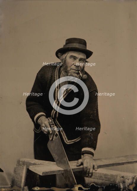 Carpenter Sawing a Plank of Wood, 1880s-90s. Creator: Unknown.