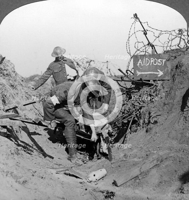 Carrying a wounded soldier to a first aid post, Passchendaele, Belgium, World War I, 1914-1918.Artist: Realistic Travels Publishers