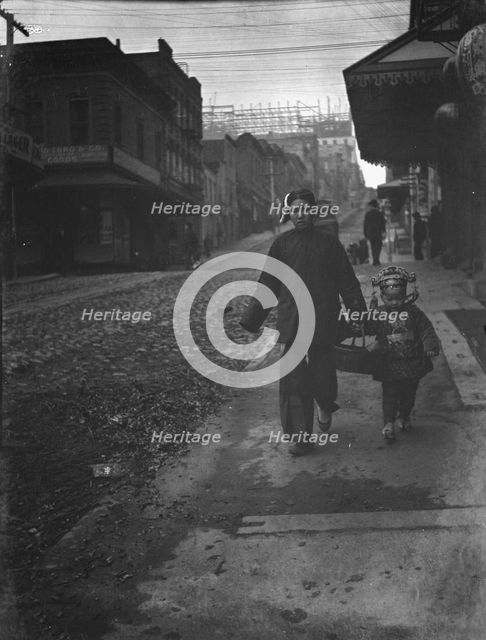 Carrying New Year's presents, Chinatown, San Francisco, between 1896 and 1906. Creator: Arnold Genthe.