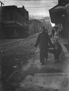 Carrying New Year's presents, Chinatown, San Francisco, between 1896 and 1906. Creator: Arnold Genthe