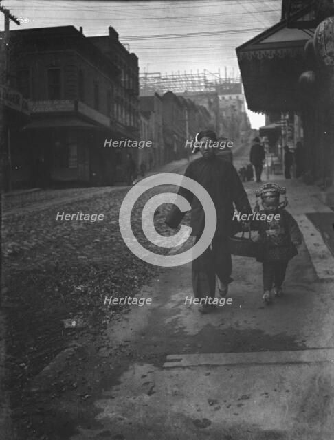 Carrying New Year's presents, Chinatown, San Francisco, between 1896 and 1906. Creator: Arnold Genthe.