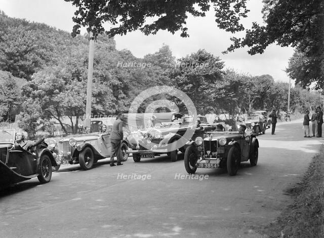 Cars competing in the MCC Torquay Rally, July 1937. Artist: Bill Brunell.