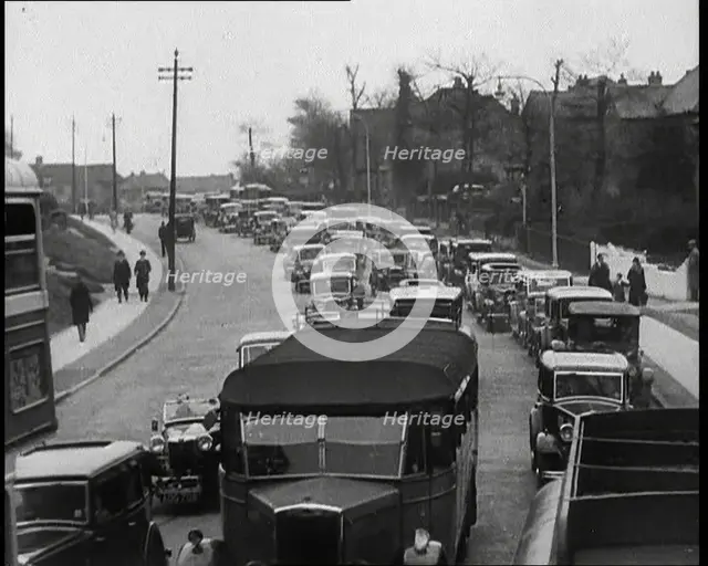 Cars Driving Down a Road Towards the Camera, 1930s. Creator: British Pathe Ltd.