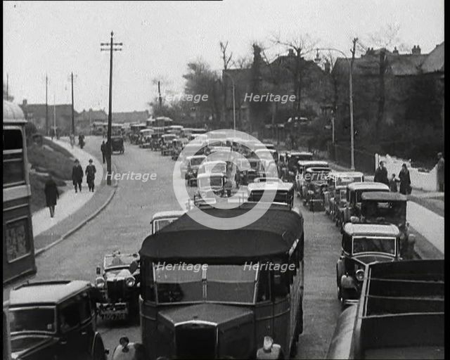 Cars Driving Down a Road Towards the Camera, 1930s. Creator: British Pathe Ltd.