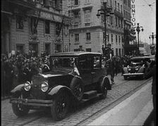 Cars Driving Down a Road, Watched by a Crowd, 1934. Creator: British Pathe Ltd