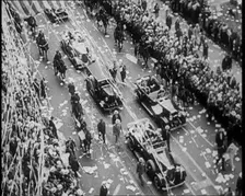 Cars Driving Down in a Parade Watched by Crowds, 1933. Creator: British Pathe Ltd