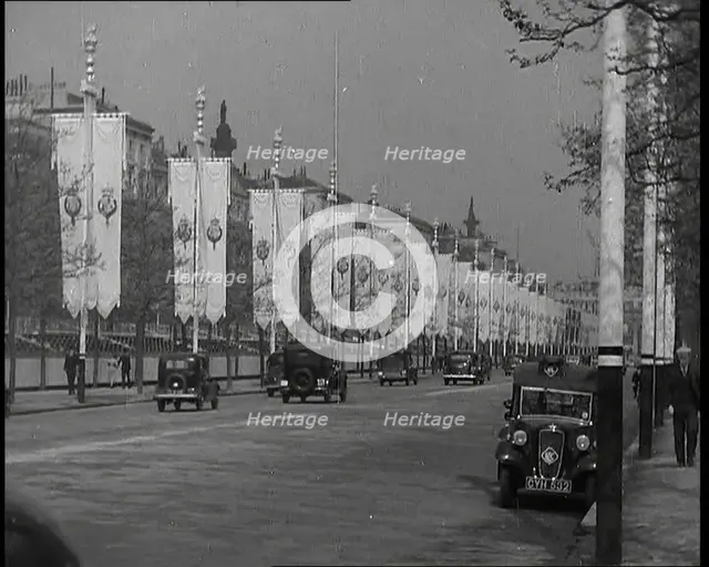 Cars Driving Down the Mall Which Is Decorated By Flags For the Coronation of King George VI, 1937. Creator: British Pathe Ltd.