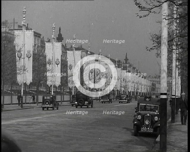 Cars Driving Down the Mall Which Is Decorated By Flags For the Coronation of King George VI, 1937. Creator: British Pathe Ltd.
