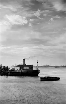 Cars embark on a ferry at Gravesend, Kent, for an evening crossing of the Thames, c1945-c1965. Artist: SW Rawlings