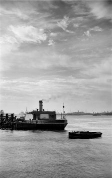 Cars embark on a ferry at Gravesend, Kent, for an evening crossing of the Thames, c1945-c1965. Artist: SW Rawlings