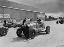 Cars of George Harvey-Noble, Charles Goodacre and Bert Hadley, BRDC 500 Mile Race, Brooklands, 1937. Artist: Bill Brunell
