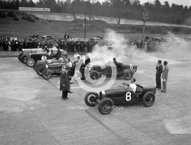 Cars on the start line at a BARC meeting, Brooklands, 1930. Artist: Bill Brunell.