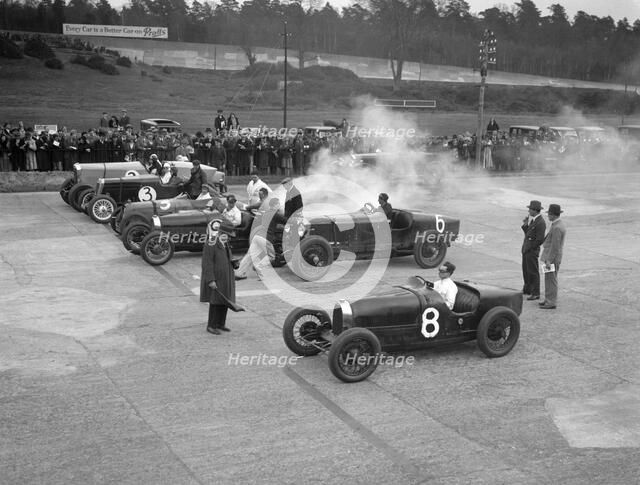 Cars on the start line at a BARC meeting, Brooklands, 1930. Artist: Bill Brunell.