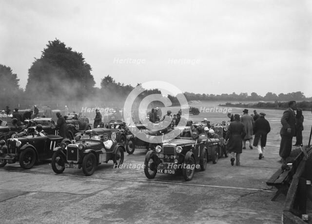 Cars on the starting grid for the Brighton & Hove Motor Club High Speed Trial, Brooklands, c1931. Artist: Bill Brunell.