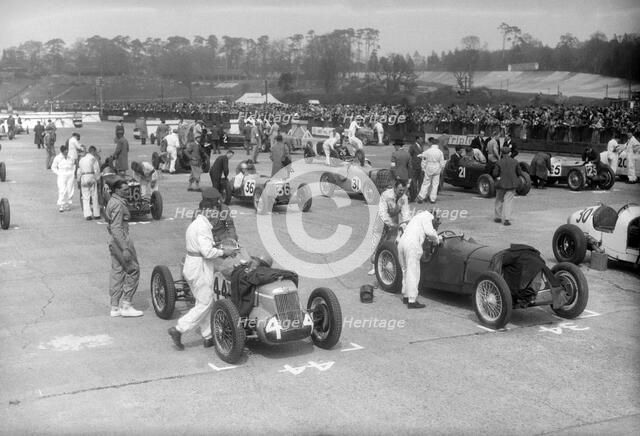 Cars on the starting grid for the JCC International Trophy, Brooklands, 2 May 1936. Artist: Bill Brunell.