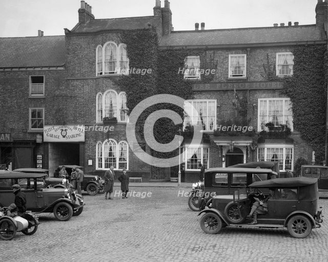 Cars parked outside the Fleece Hotel, Thirsk, Yorkshire, Ilkley & District Motor Club Trial, 1930s. Artist: Bill Brunell.