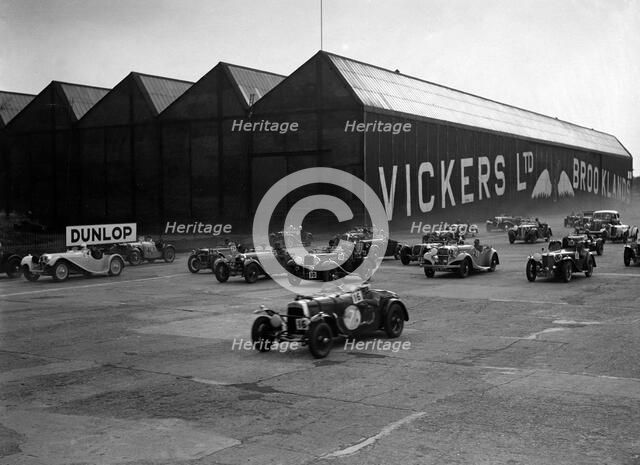 Cars racing at the MCC Members Meeting, Brooklands, 10 September 1938. Artist: Bill Brunell.