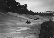 Cars racing on the Members Banking at a JCC Members Day, Brooklands. Artist: Bill Brunell