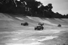 Cars racing on the banking at a JCC Members Day, Brooklands. Artist: Bill Brunell